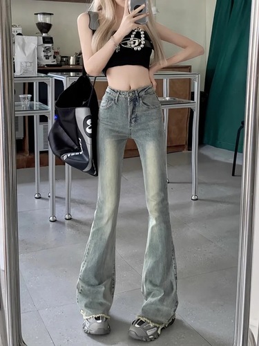 Slightly flared denim jeans for women: vintage autumn style, high waist, slimming fit, with a niche design and raw-edge hem.