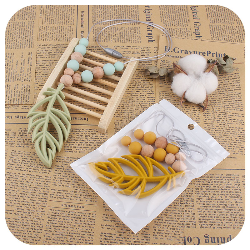 Nuevo bebé suministros silicona hoja mordedor collar fábrica directa pluma collar bebé calmante mordedor palo