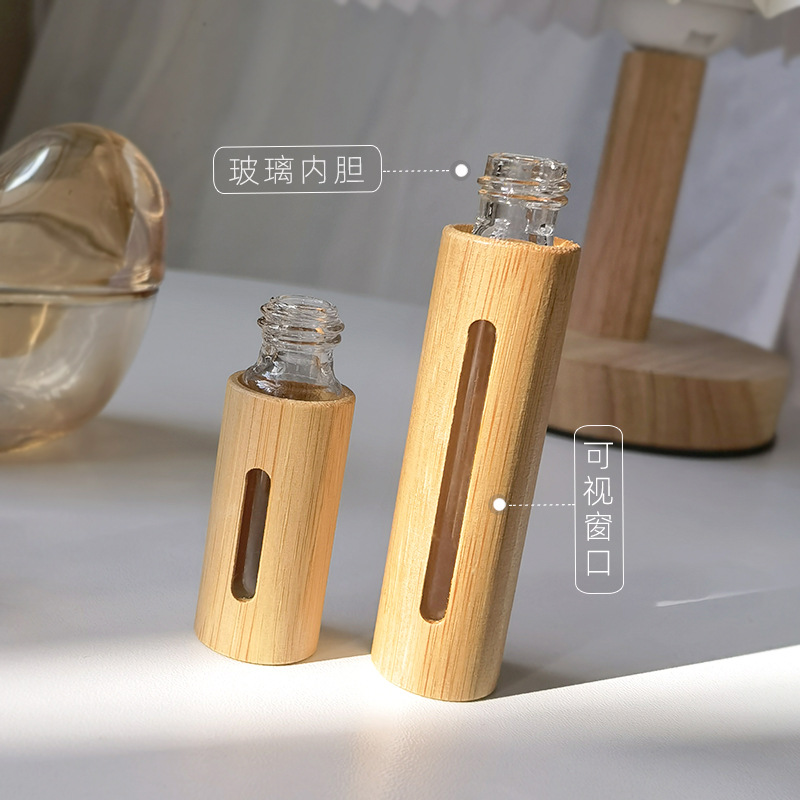 En stock al por mayor 5ml10ml botella de spray de bambú forro de vidrio boquilla electroquímica de aluminio perfume embalaje de embalaje botella vacía