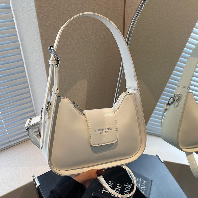 Nicho Zhong simple y versátil bolso de brazo para mujeres 2025, nuevo estilo de moda casual bolso de hombro de alta sensación bolso de media luna de mano