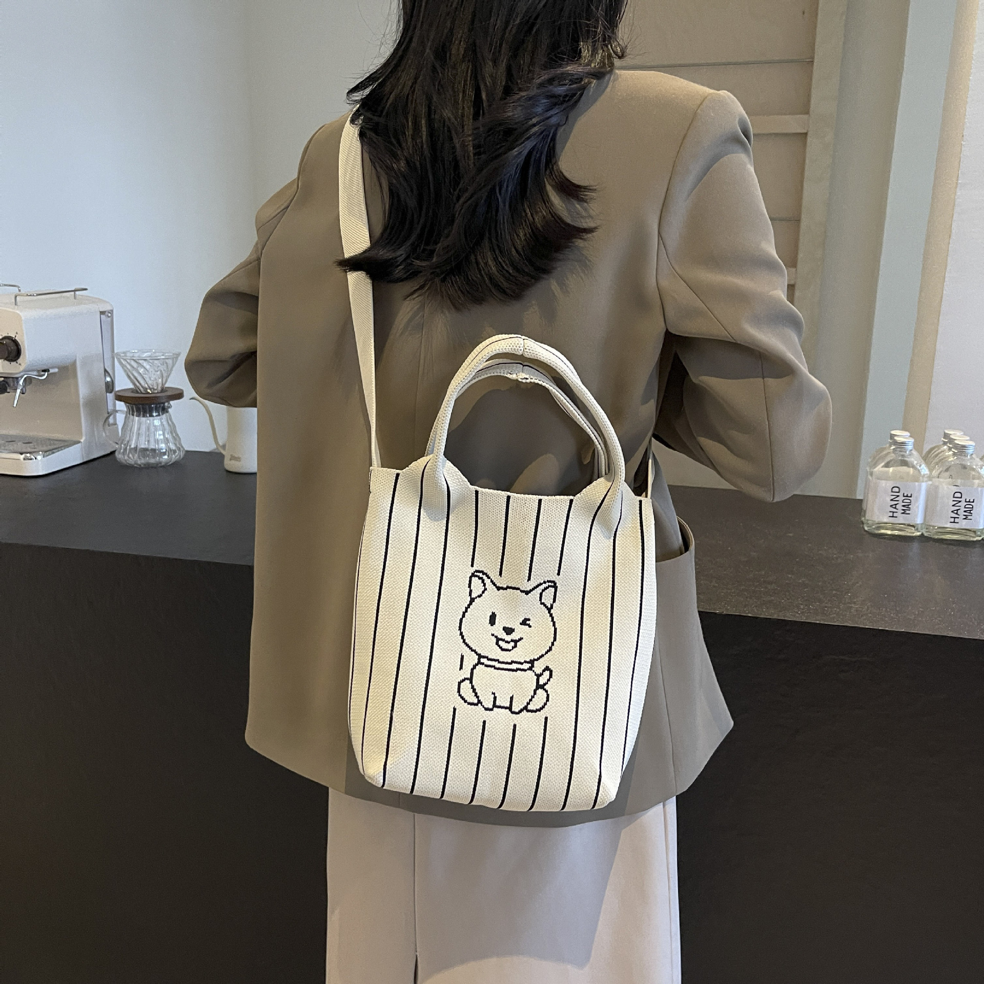 This handbag is a stylish knitted striped shopping bag. It's a popular lady's bear large-capacity tote single-shoulder bag for going out details Picture