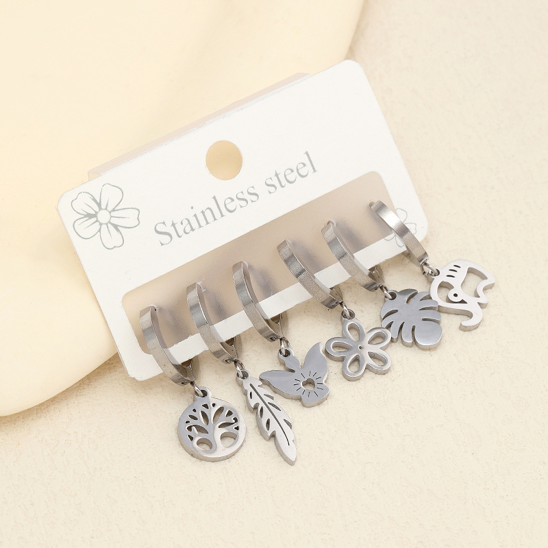 Joyería de acero inoxidable transfronterizo corte hueco flor planta Awn estrella patrón geométrico oreja dorada hebilla traje fabricante