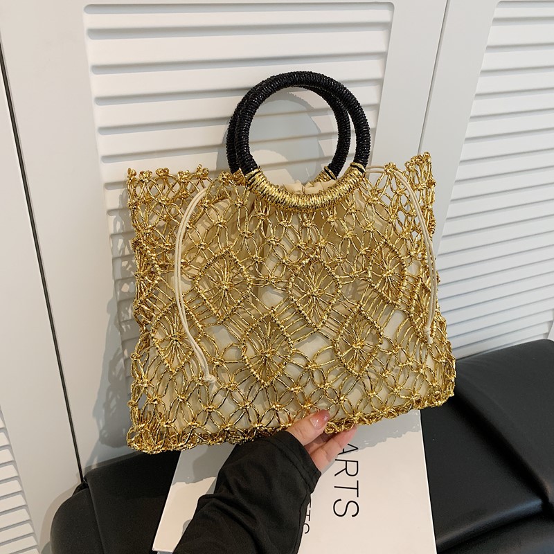 Bolso de vacaciones junto al mar 2025 verano nuevo bolso femenino bolso de playa de estilo occidental bolso tejido hueco de gran capacidad