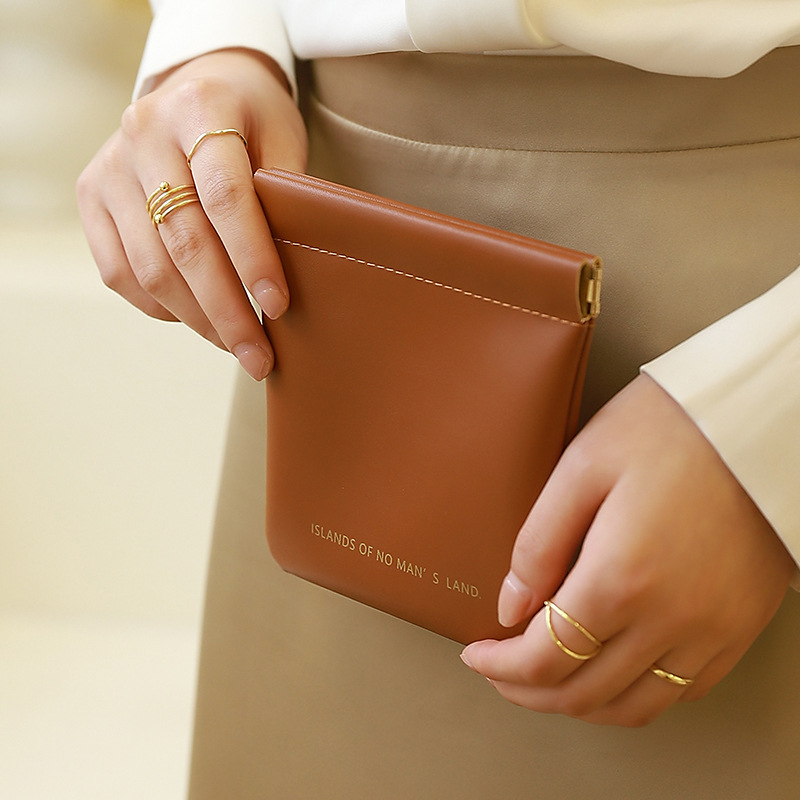 Bolsa de almacenamiento de servilleta sanitaria de color sólido de estilo coreano engrosada PU multi-funcional bolsa de lápiz labial impermeable tía toalla bolsa de almacenamiento al por mayor