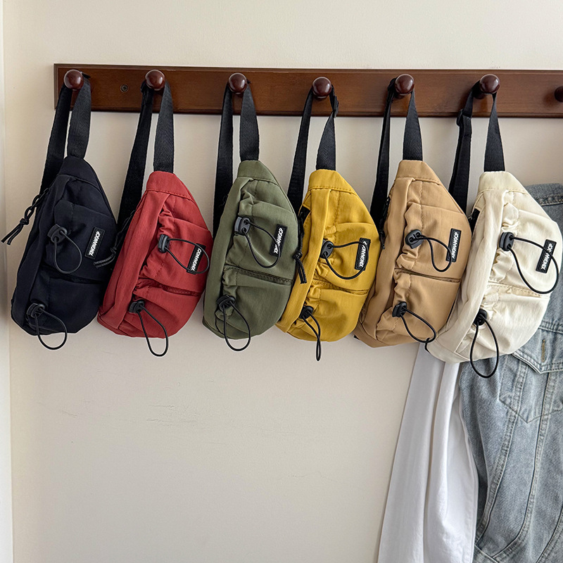 Bolsos de pecho para niños y niñas populares coreanos, deportes de ocio, letras extranjeras, bolsillos para niños, bolsos diagonales para niños de color sólido simple