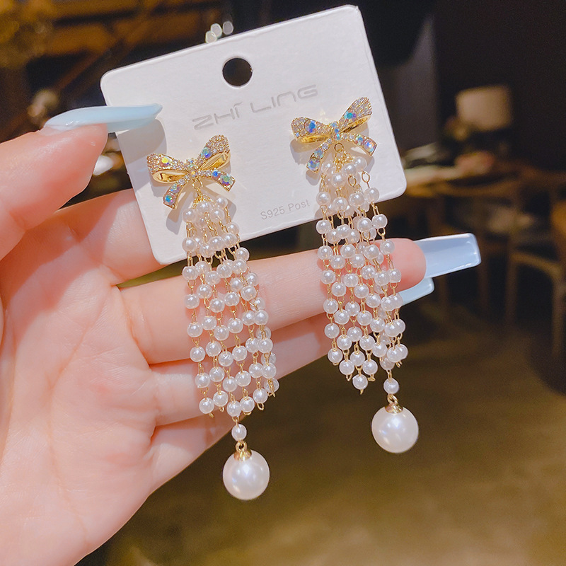 Fashionable earrings with zircon with bow pearl