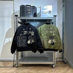 アメリカの純粋な元の復古の高い街の刺繍のアルファベットのパイロットのジャケットのゆったりした野球の服のコートのファッションのブランドの男女は百合します。