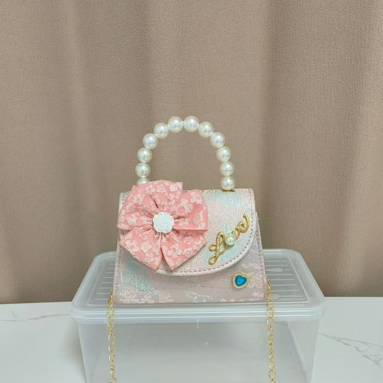 Bolsa infantil nueva niñas bolso de hombro accesorios de ropa china bolso cuadrado princesa bolso de perlas bolso arco bolso de mochila