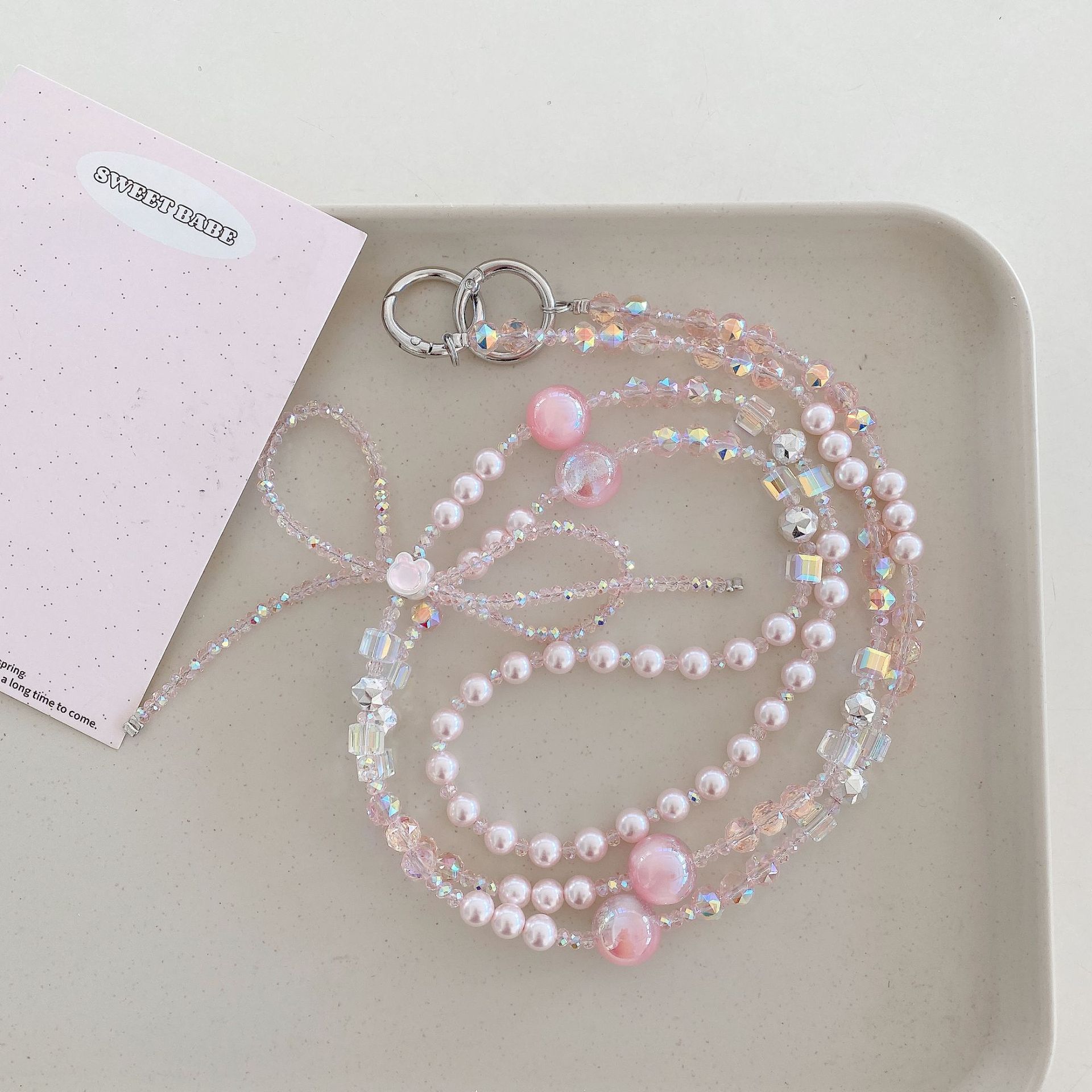 Boutique hecho a mano cadena colgante de alta gama arco fresco de cuatro colores cadena larga cordón de teléfono móvil de moda mensajero largo/colgante