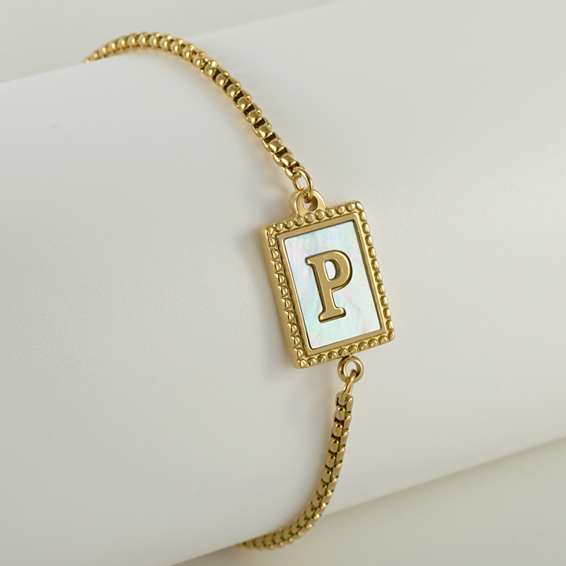 Nuevo europeo y americano transfronterizo de acero inoxidable 26 letras inglesas Shell pulsera personalidad todo partido titanio acero 18K cremallera