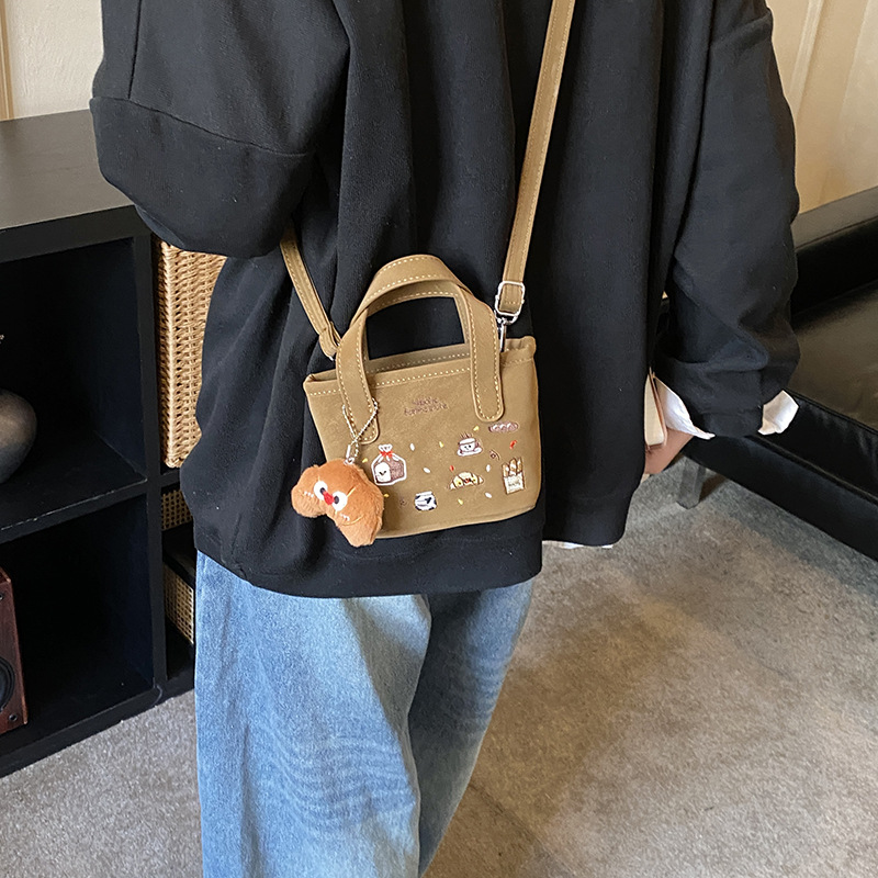 2026 nuevo comercio exterior bolsas de niños dibujos animados lindos colgantes de peluche bolsas de mano bordadas de moda bolsas de hombro para hombres y mujeres