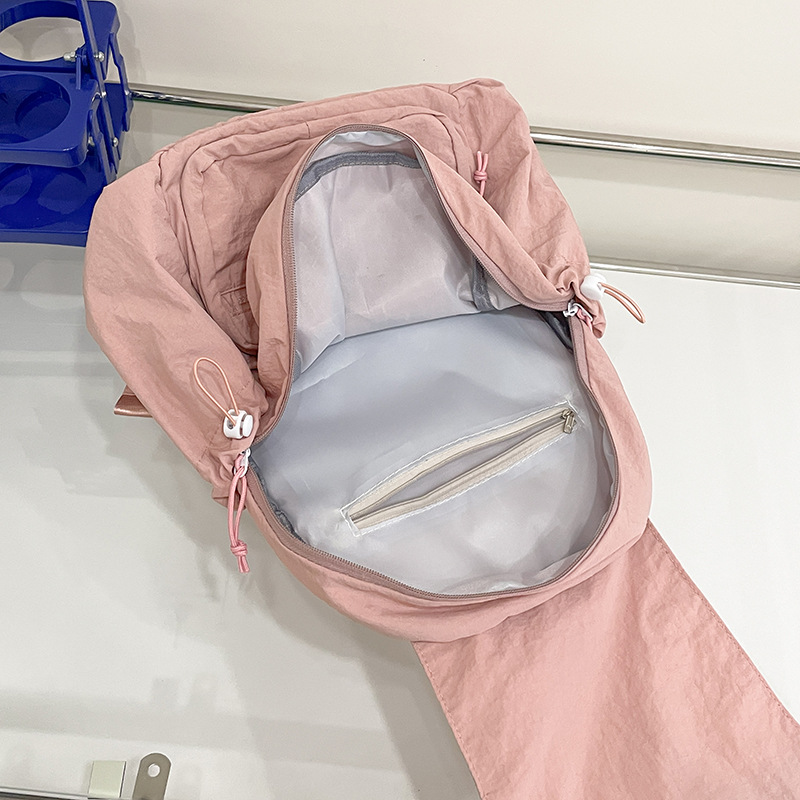 2024 nueva mochila casual de nailon, mochila escolar pequeña de color sólido de viaje coreano, bolsa de clase ligera de gran capacidad y versátil