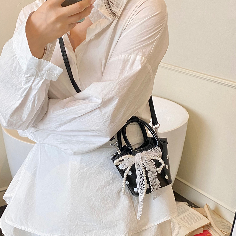 Xiaozhong Mini onda punto bolso de mujer 2025 nuevo estilo coreano de moda versátil bolso portátil pequeño bolso de cubo