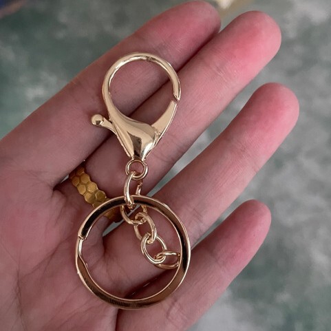 金属メッキのロブスターの鍵は腰の間の掛け物を掛けます。|undefined
