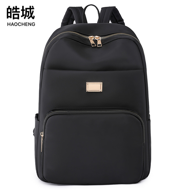 Comercio exterior al por mayor 2023 verano nuevo estilo versión coreana de las señoras mochila de nailon mochila simple de color sólido de gran capacidad para estudiantes