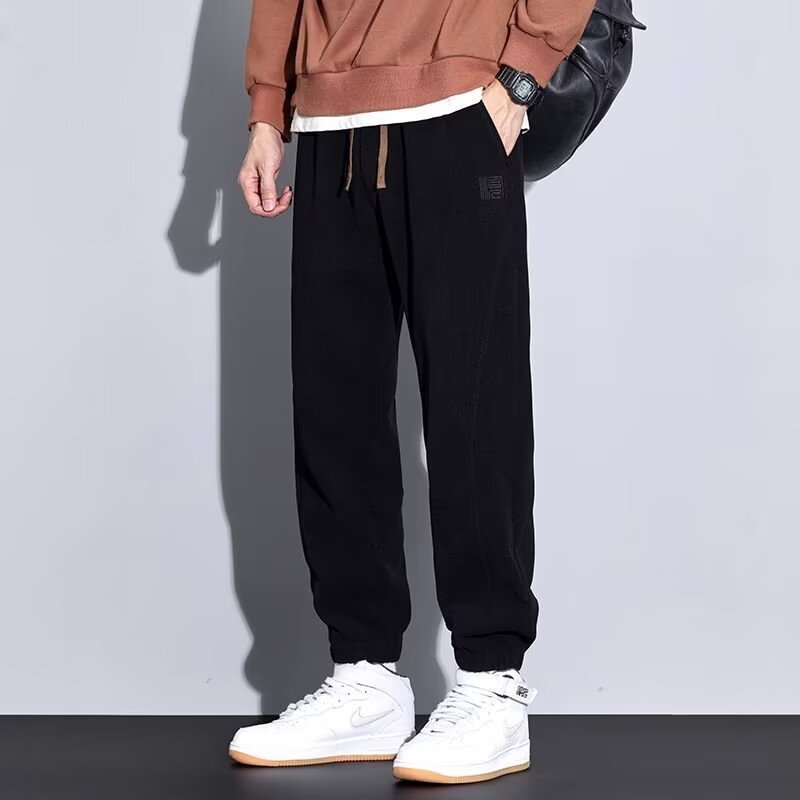 2025 invierno de lana más gruesa pantalones casuales de hombre calentamiento sueltos versátiles pantalones deportivos de empalme de moda