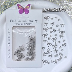 クロスボーダーのネイルアートの合金の小さいアクセサリーの金属の蝶結びの爪の小さいアクセサリーの透かし彫りの合金のミニのリボンは銀色を結びます。