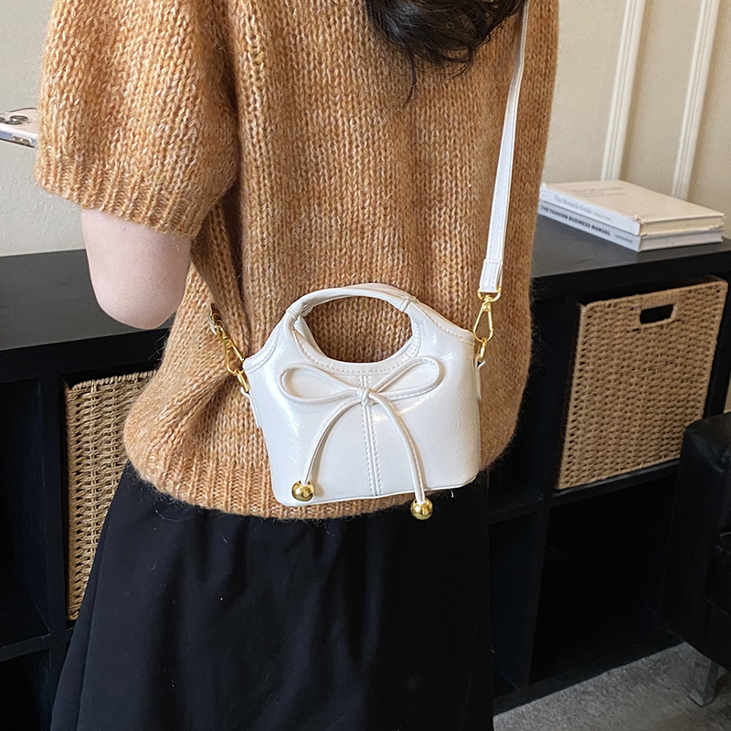Bolsas infantiles transfronterizas de moda coreana de color sólido, bolsas de mano de chicas, mini bolsas de cestas de arco lindas