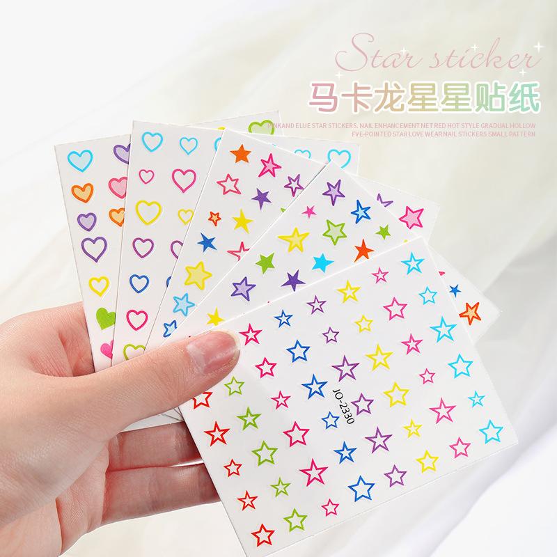 Nuevo en línea popular macaron Linda estrella de dibujos animados decoración de uñas pentagrama hueco uñas pegatinas al por mayor