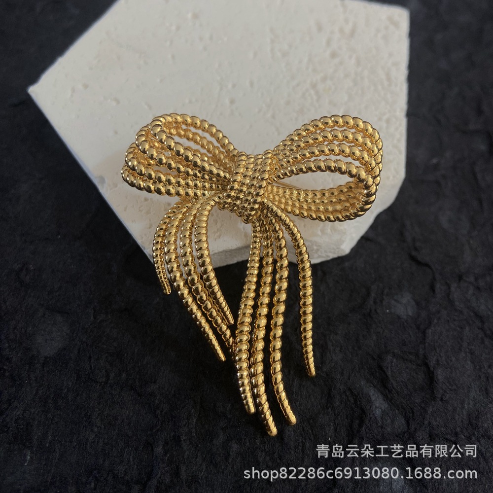 Brass brooch with bow
