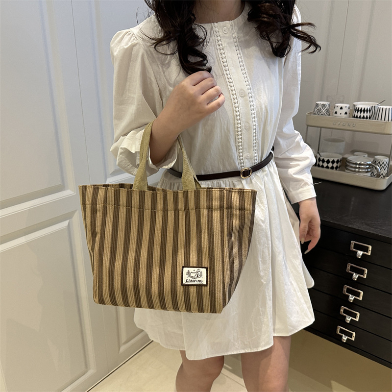 Bolso tote de tela a rayas de estilo europeo y americano, nuevo bolso pequeño de moda, bolso femenino portátil, bolso de almuerzo de mano, bolso de bocadillos