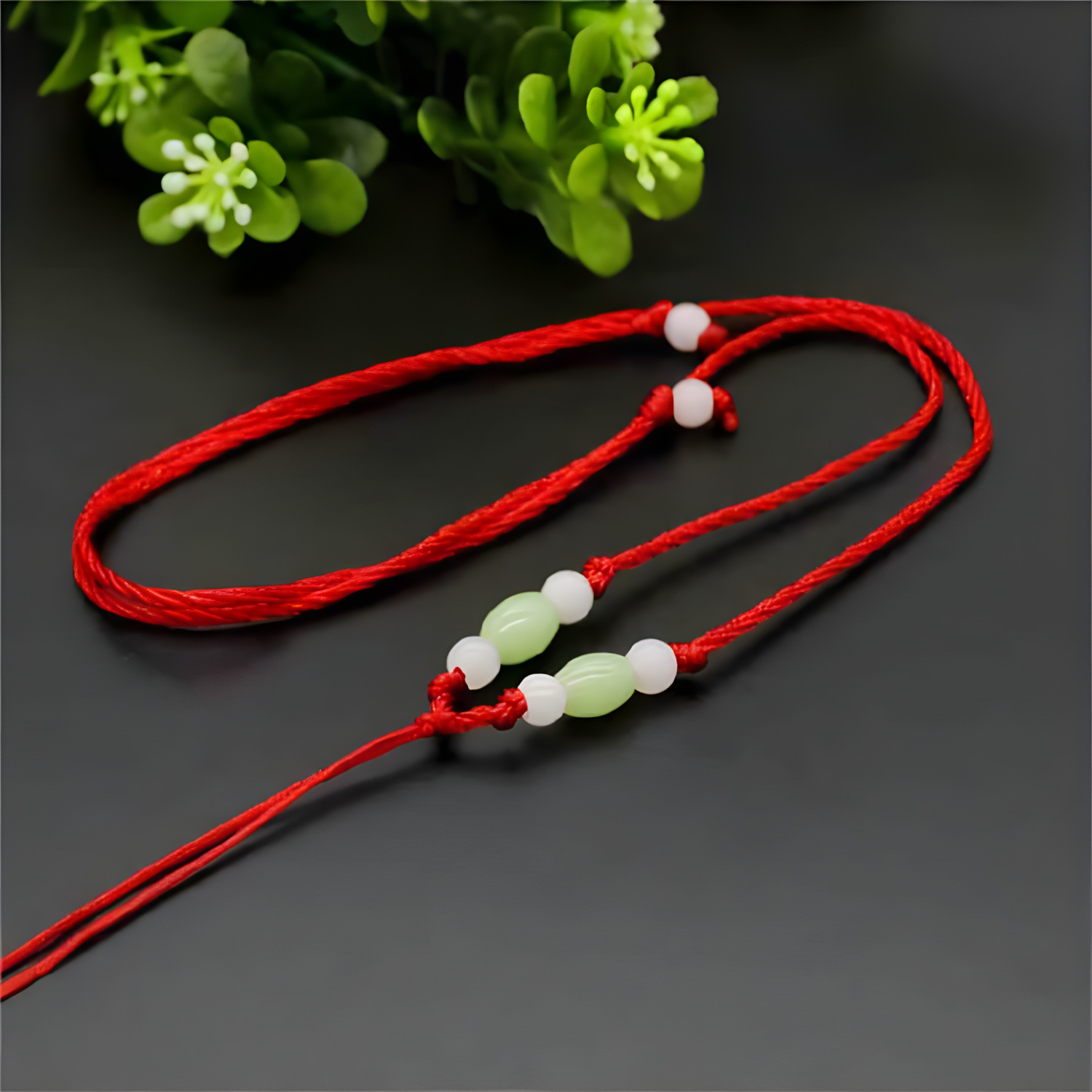 Add green rice beads and red thread