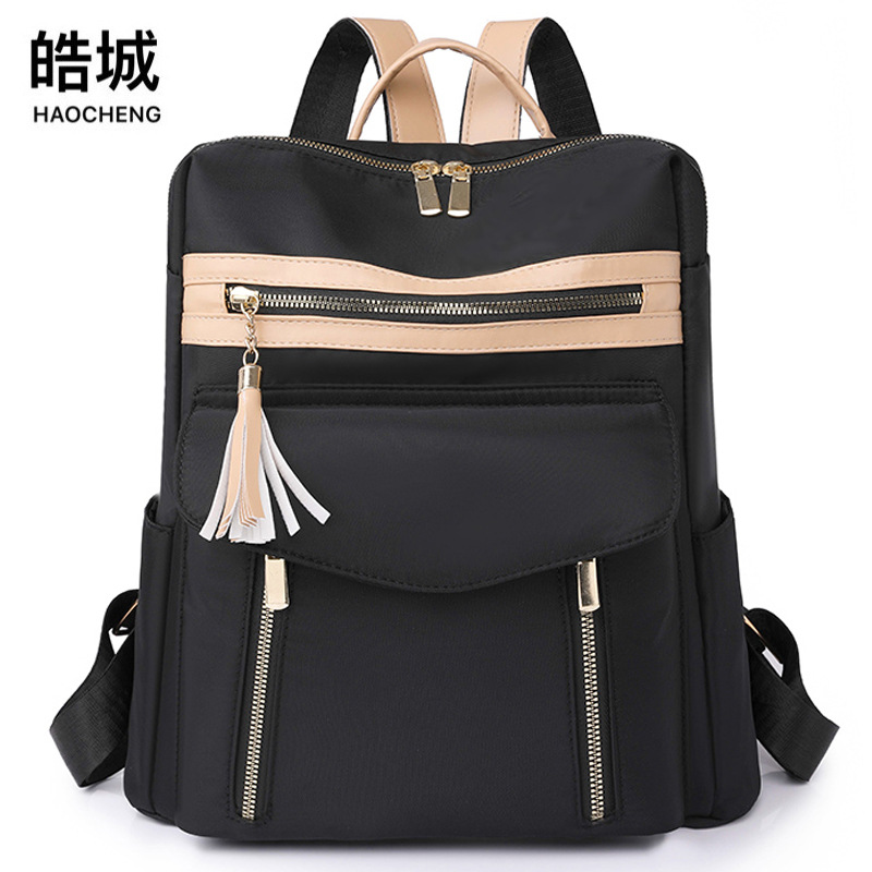 2023 nueva mochila de nailon para mujer simple moda borla literatura mochila de viaje de gran capacidad mochila escolar al por mayor