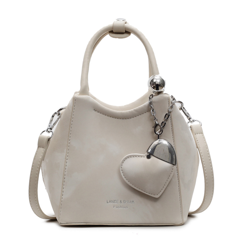 Nicho de diseño de bolsas de cubo de mano para mujeres 2025 nuevo estilo coreano bolso de hombro universal de moda retro bolso de mochila