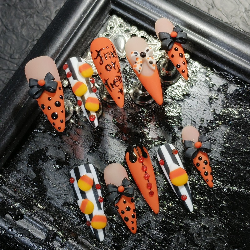 European and American Halloween handmade nail art: long, pointed nails, candy corn design, 3D bow, leopard print, zebra print, finished nail designs European and American Halloween handmade nail art: long, pointed nails, candy corn design, 3D bow, leopard print, zebra print, finished nail designs