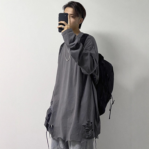 Basic shirt with a distressed hem, white long-sleeve T-shirt—men's Instagram-worthy high-street style for layering and edgy, stacked-look outfits.