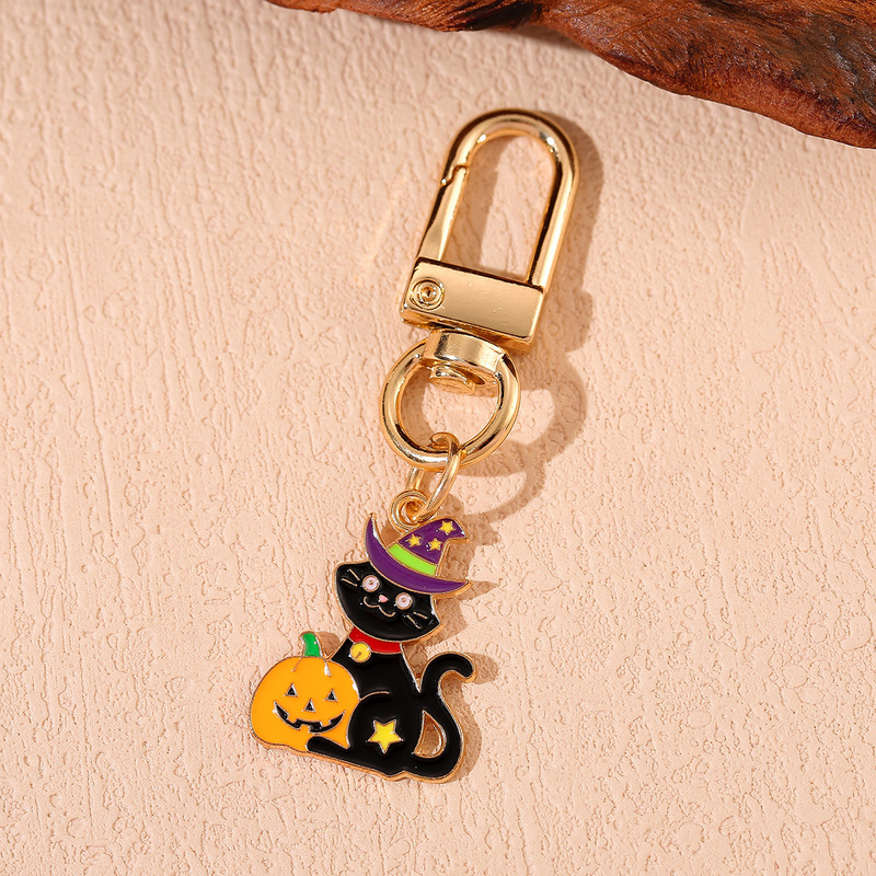 国境を越えてハロウィーンシリーズのアニメかわいいカボチャの頭帽の幽霊のキーホルダーに飾られた女性の本のストラップ|undefined