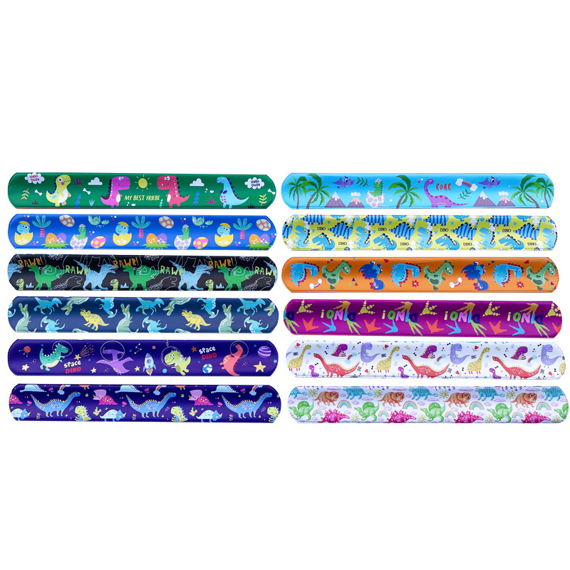 Nuevo mundo jurásico dinosaurio Snap anillo retro dinosaurio huevo huellas partido PVC raqueta anillo pulsera de los niños