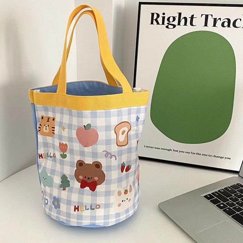 かわいい落書きバケツバッグinsプリント円筒バッグキャンバス弁当袋韓風少女は弁当箱を持っています。|undefined