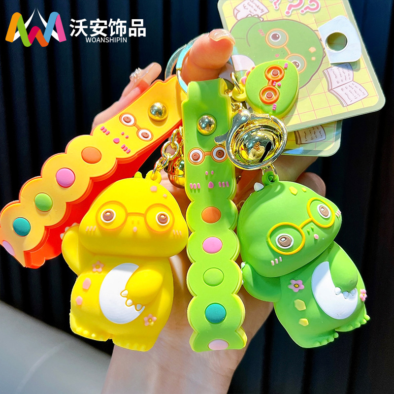 Keychain dinosaurio auténtico lindo bolso colgante de goma blanda llavero de automóvil muñeca pequeña máquina de regalos al por mayor image 1