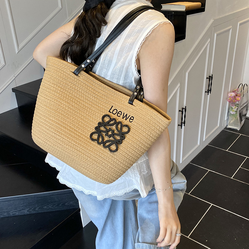 Bolso tejido femenino de gran capacidad 2025 verano nuevo bolso de playa de vacaciones junto al mar estilo de viaje bolso tejido de paja portátil