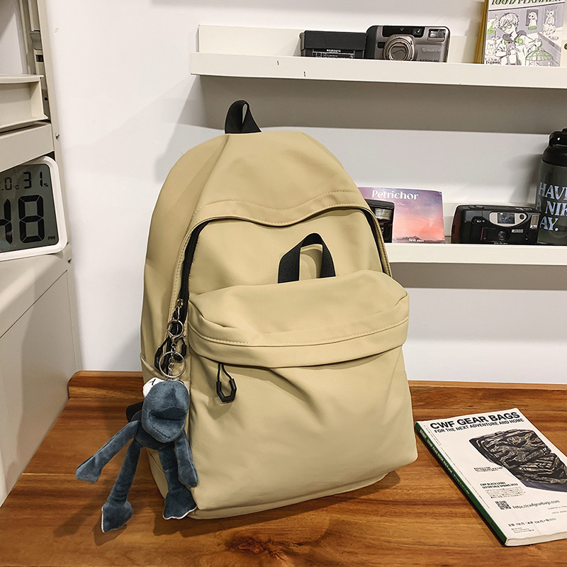 Las chicas japonesas de bolsos de lona son antiguas, impermeables, de color sólido, bolsos de nylon, Campus simple y versátil mochilas escolares para hombres de moda.