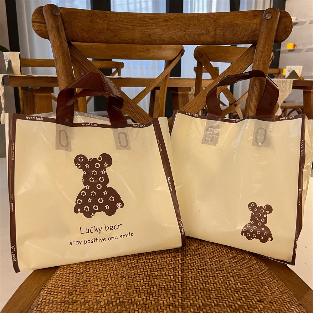 卡通可爱服装店用简约塑料包装手提袋子快乐熊logo塑料礼品袋小熊