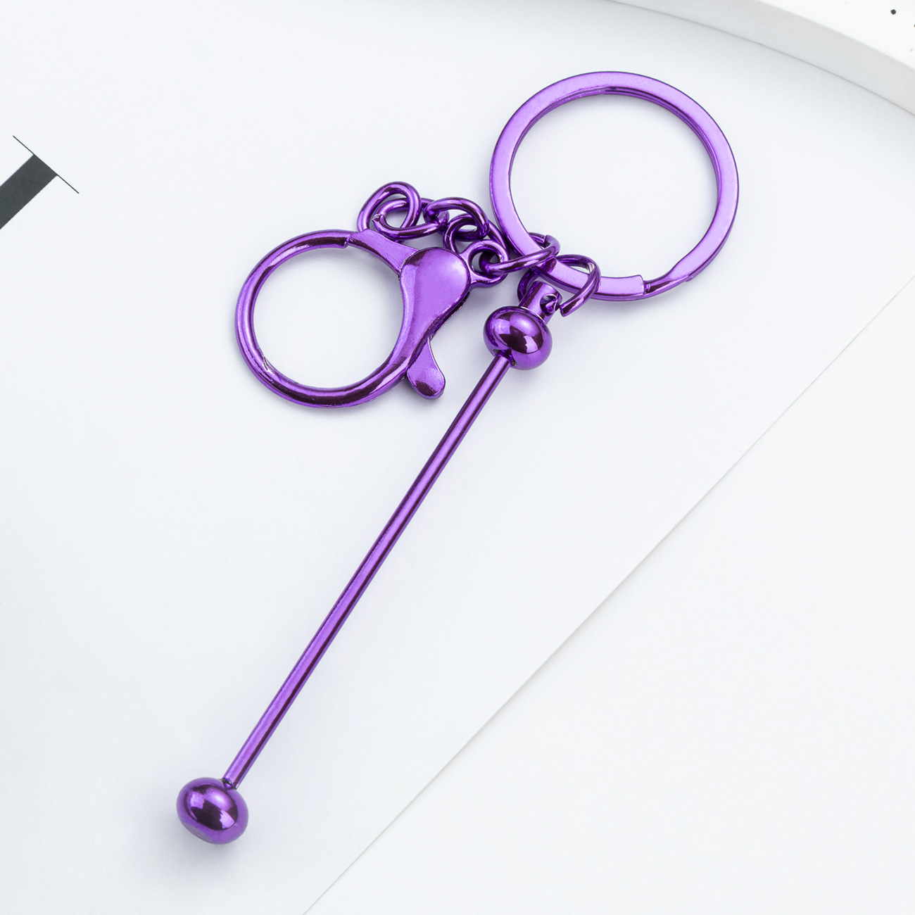 DIY cuentas llaveros auriculares caja de teléfono celular colgante llaveros de metal chapeado UV llaveros al por mayor spot