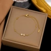 Golden bracelet with zircon with bow