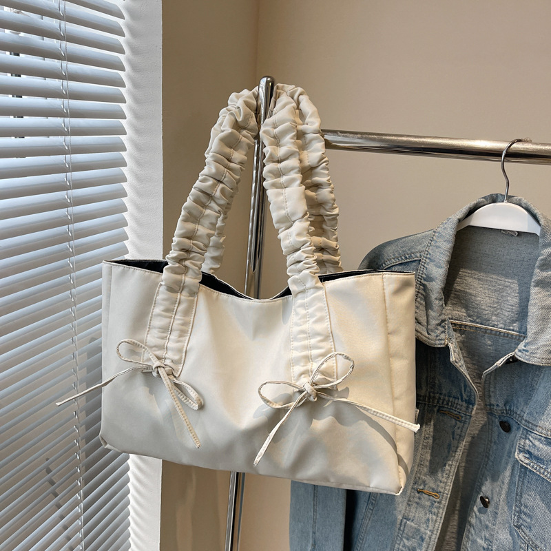 Bolso de arco de la mujer 2025 nueva moda coreana bolso de tela de gran capacidad bolso de mujer de alto valor facial