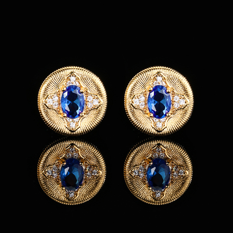 Otoño e invierno nuevo estilo Zhuang Shengsheng joyería fondo de cobre chapado en oro nueva simulación corindón rojo cristal puntiagudo azul piedra redonda retro 5*7