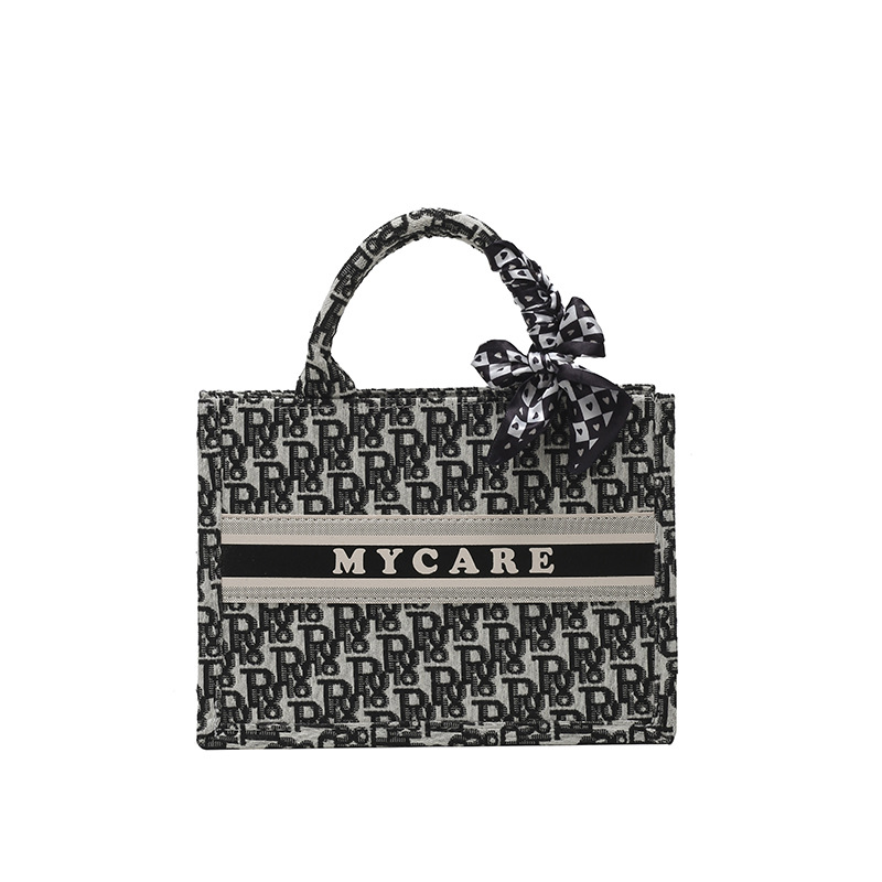 Bolsos bordados de alta calidad para mujeres 2026 nuevas letras de tela transfronterizas retro bolsas de mano de transporte de gran capacidad