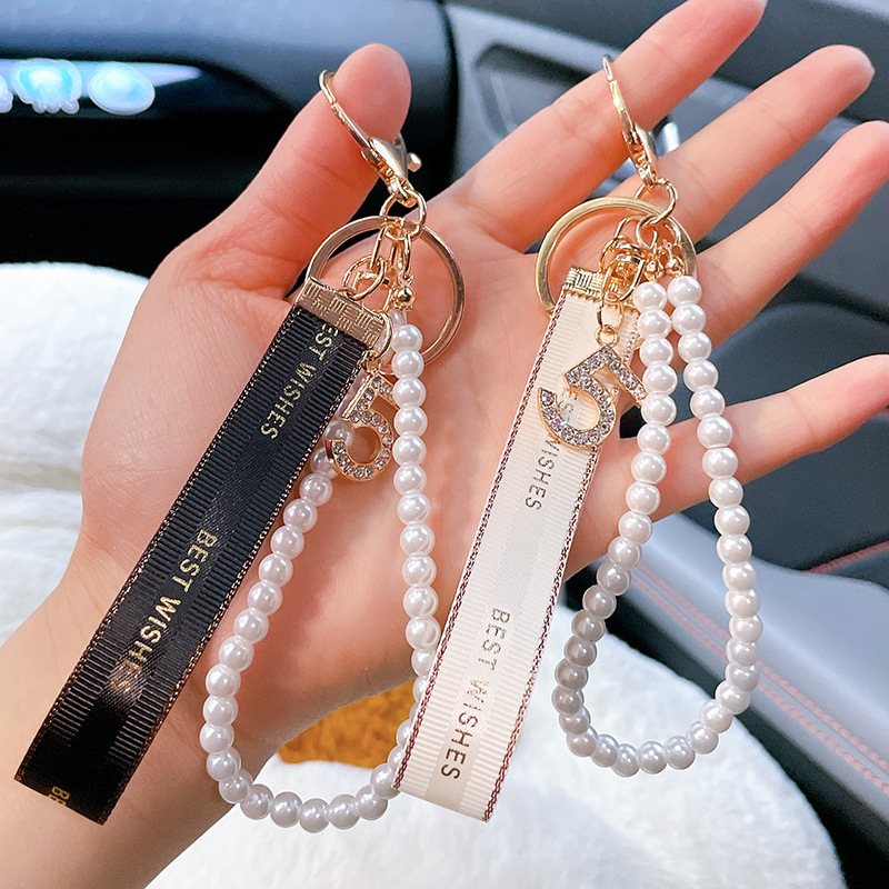 Nuevo simple llavero de arco de perla pequeño bolso colgante de automóvil interior colgante al por mayor
