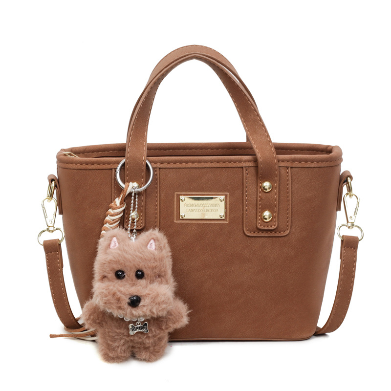 Alta sensación retro esmerilado bolso de cubo portátil 2025 otoño y invierno nuevo bolso de hombro de mujer de viaje versátil mochila