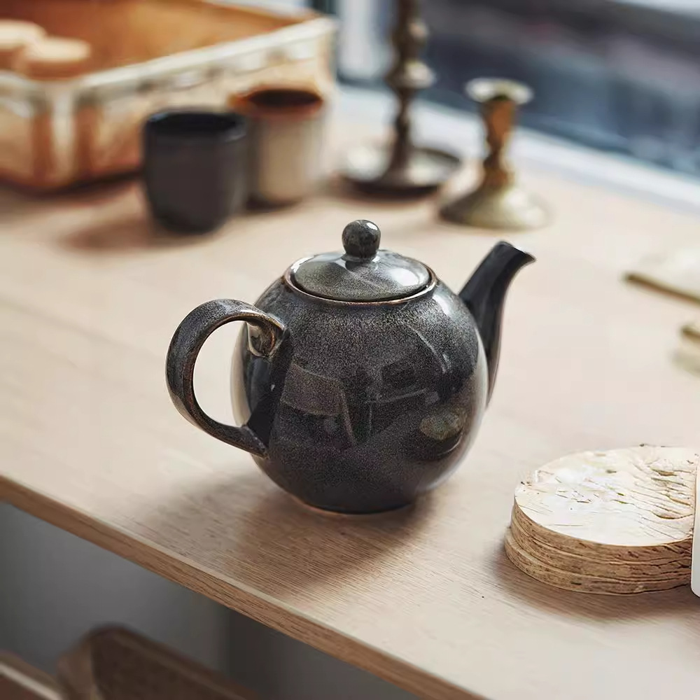 Tetera de cerámica europea creativa tetera de té de la tarde tetera de té de kung fu doméstica tetera de té de alta temperatura tetera de agua redonda de color
