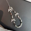 Strap with bow pearl