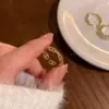 Golden ring with stone with zircon, micro incrustation