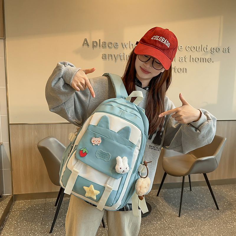 La versión coreana de las mochilas escolares de doble hombro está llena de mochilas escolares de primaria y mochilas escolares de tendencia de la escuela secundaria de gran capacidad.