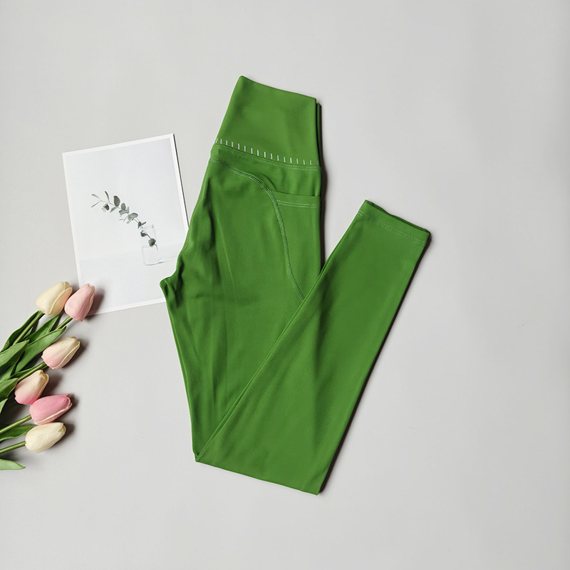 Pantalones de fitness desnudos para mujeres sonrientes líneas de elevación de cadera pantalones deportivos para mujeres al aire libre cintura alta sin marcas nueve puntos pantalones de calzado