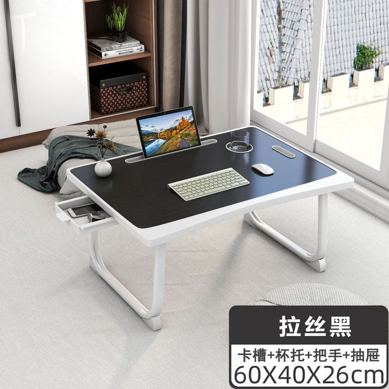 ベッドの上の机のノートパソコンの机は折りたたみ可能です。|undefined